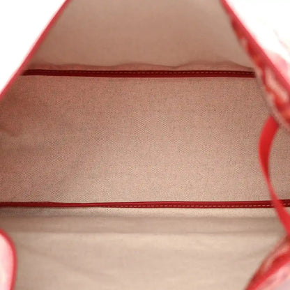 Red fabric interior of a Goyardine hobo bag with stitched trim