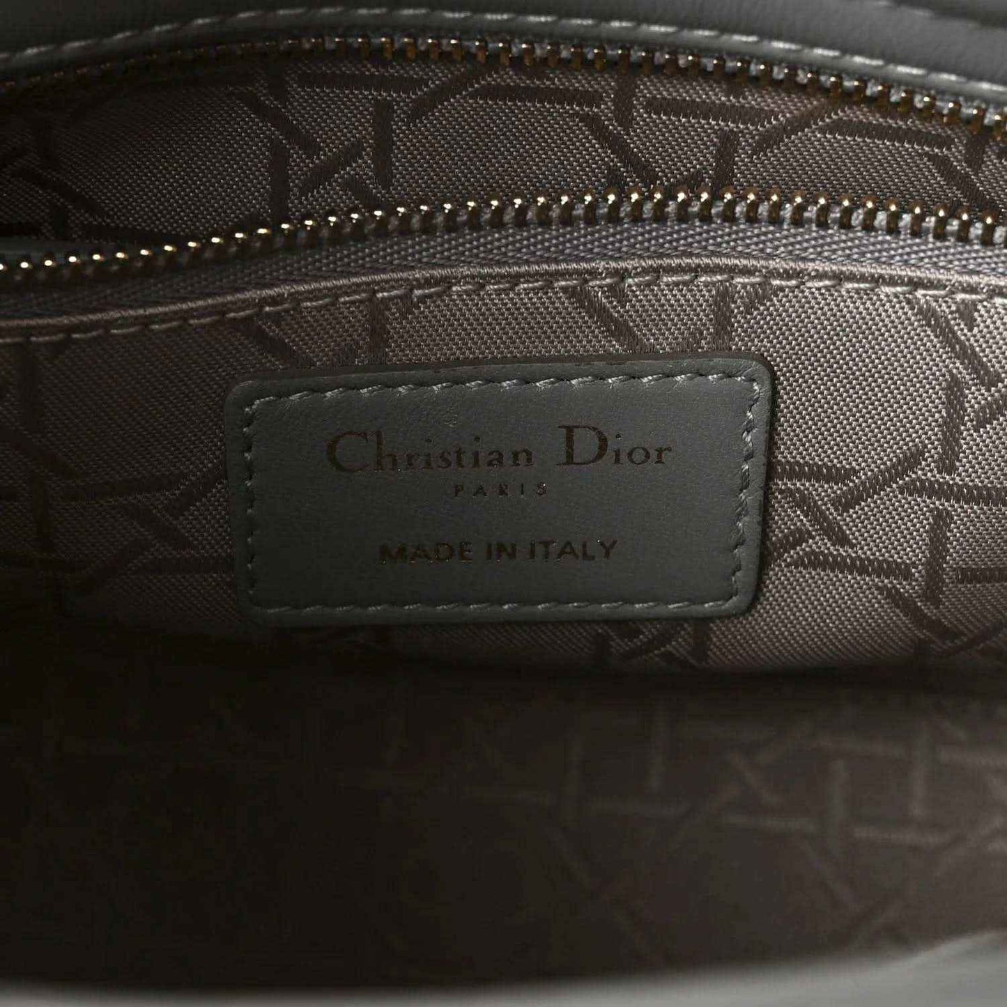 Grey jacquard interior with Christian Dior Paris label, made in Italy, and zipper