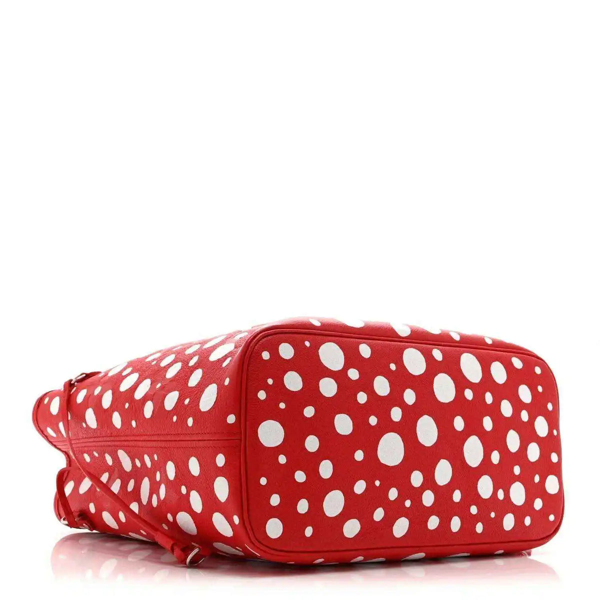 Red polka-dot shoulder bag with white dot pattern and rolled side profile