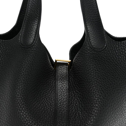 Black textured leather tote with gold lock tab and matching zipper