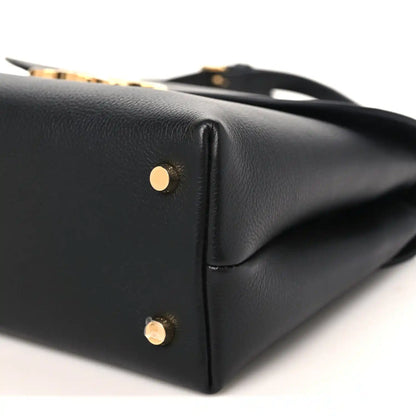 Black Celine medium shoulder bag end view with gold-tone studs on leather