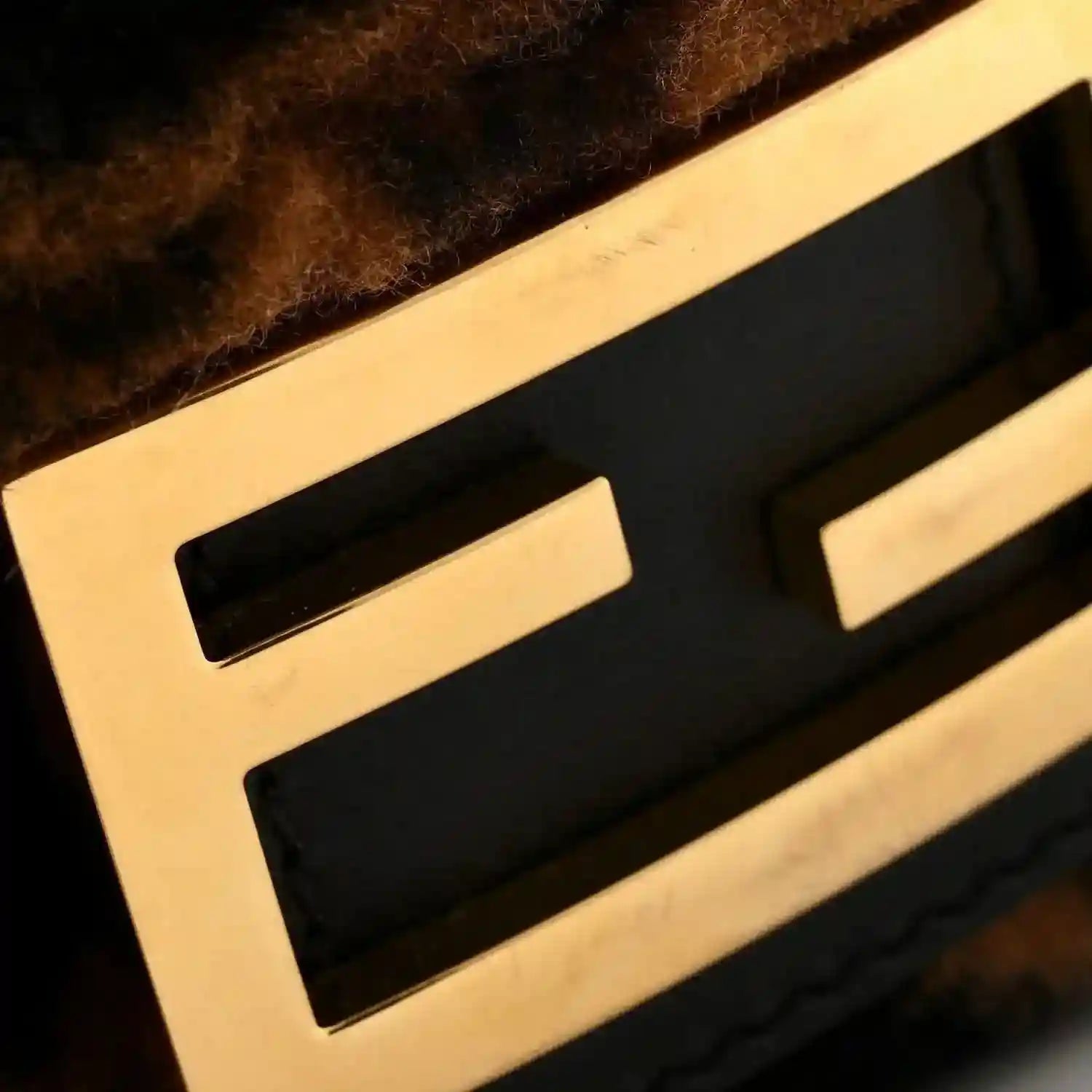 FF logo detail in black on tobacco-brown shearling of the Baguette bag.