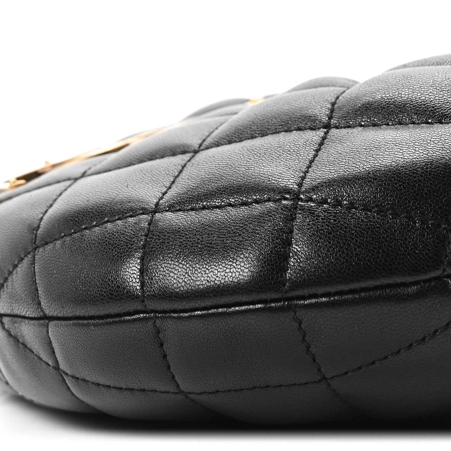 Quilted black leather bag corner with visible panel stitching