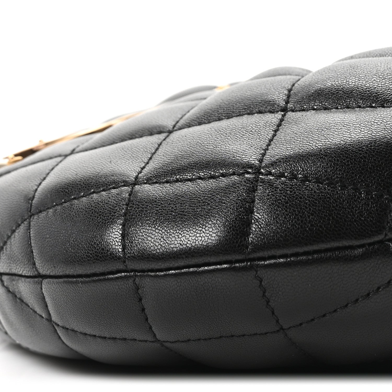 Quilted black leather bag corner with visible panel stitching