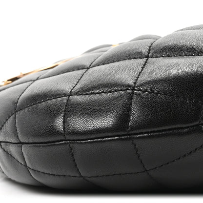 Quilted black leather bag corner with visible panel stitching