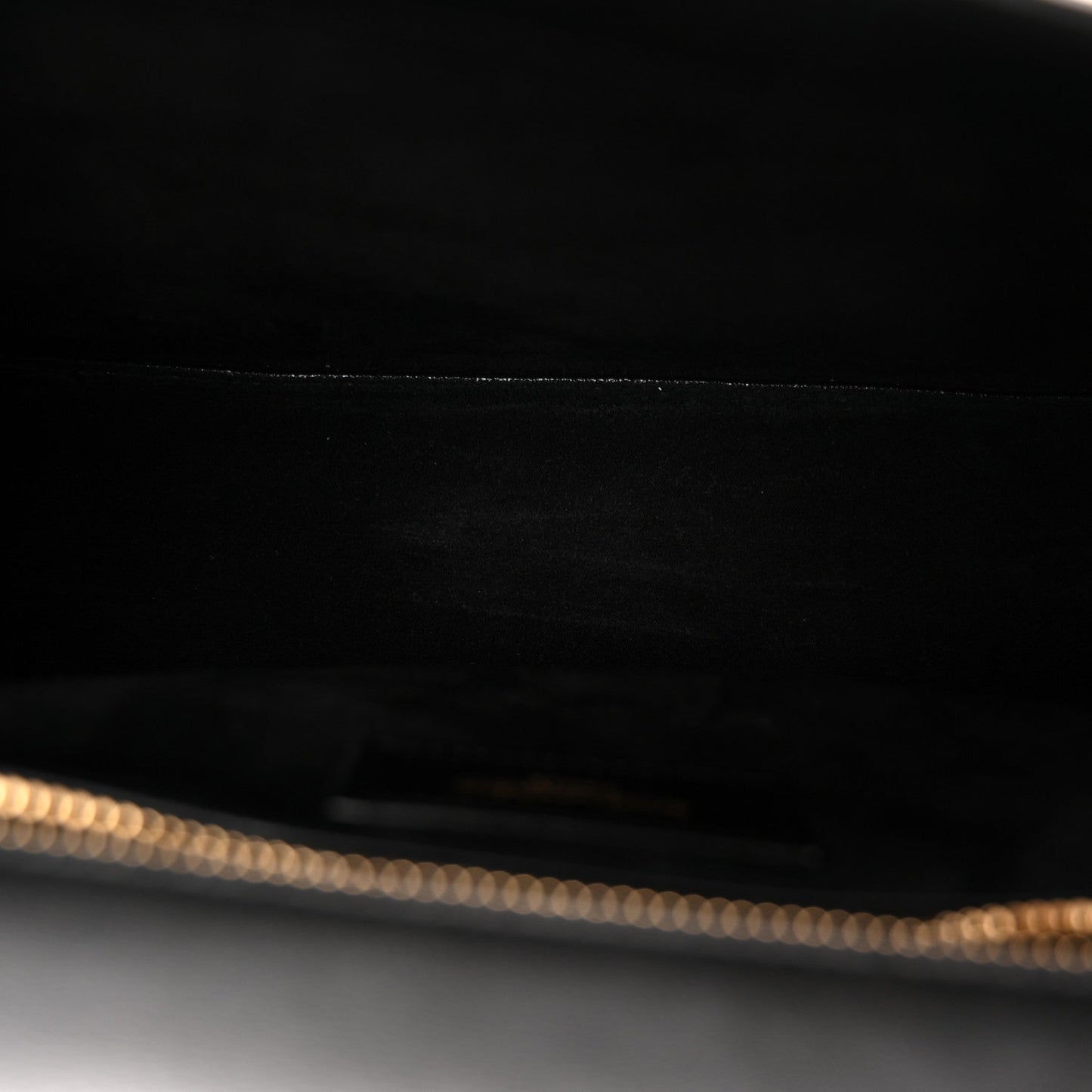 Saint Laurent black leather bag interior with gold-tone chain detail