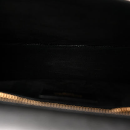 Saint Laurent black leather bag interior with gold-tone chain detail