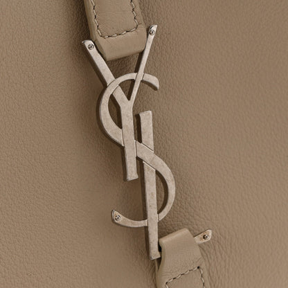 YSL metal logo and hanging leather tag on sea-salt beige hobo bag