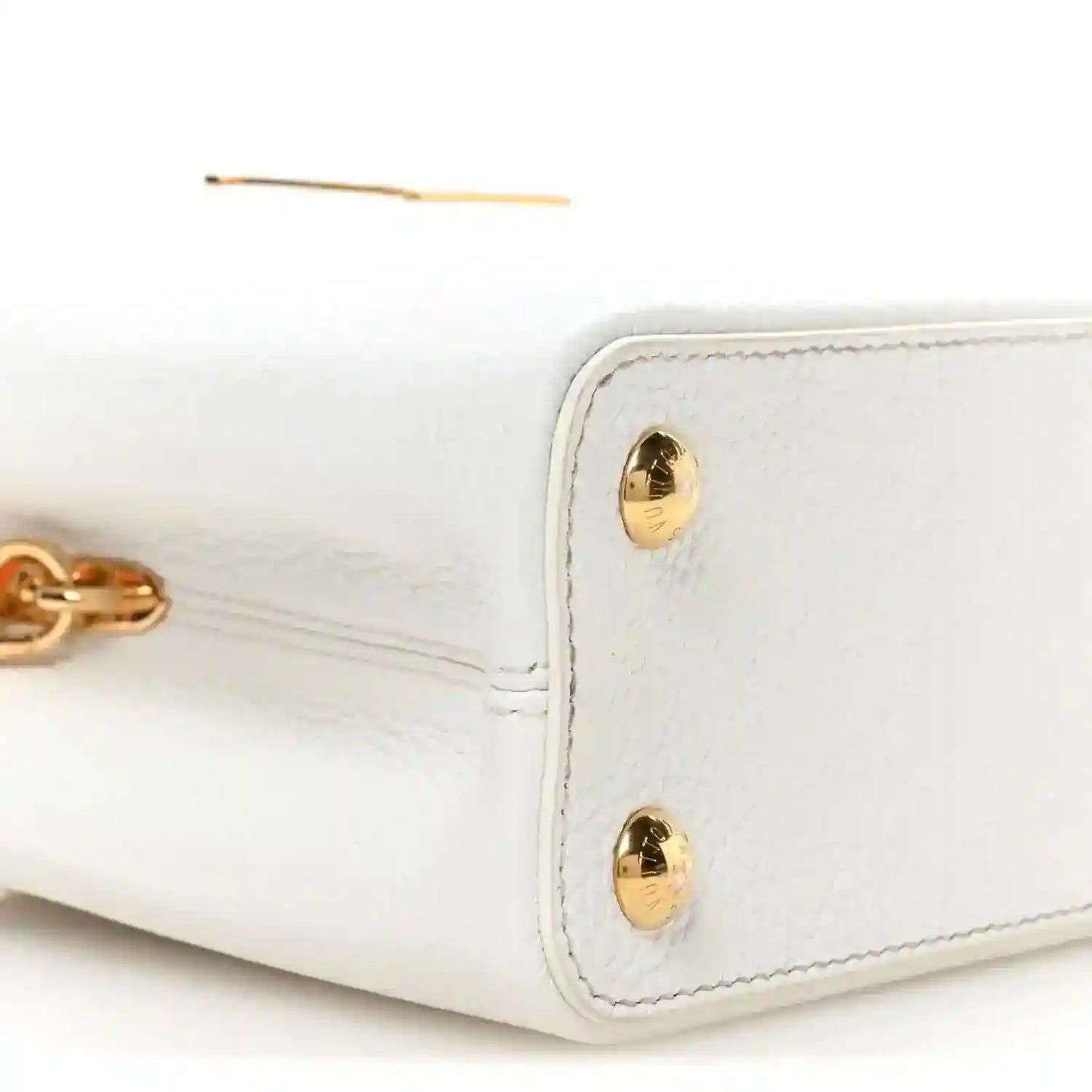 White leather handbag with gold-tone clasp hardware on the side