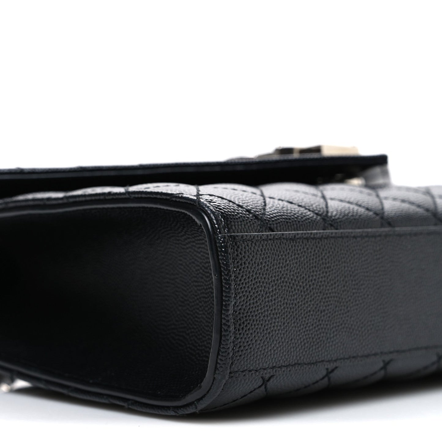 Black quilted leather satchel side with smooth trim and top handle strap
