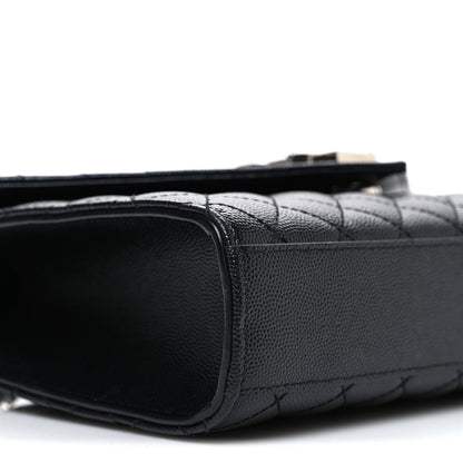 Black quilted leather satchel side with smooth trim and top handle strap