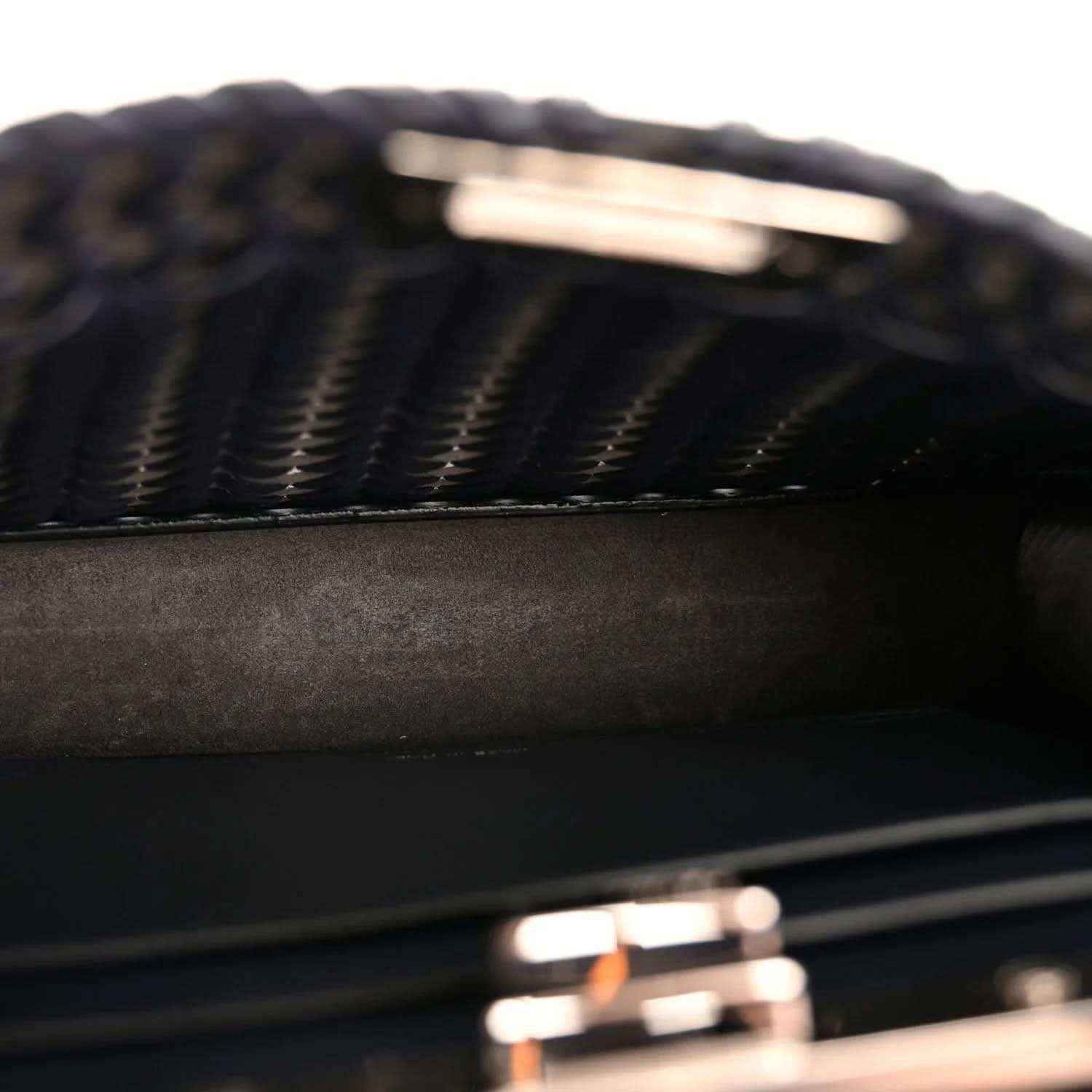 Close-up of dark blue nappa satchel with chevron woven pattern and leather panels