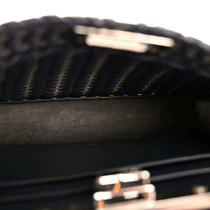Close-up of dark blue nappa satchel with chevron woven pattern and leather panels