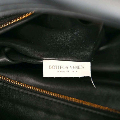 Black leather bag interior with Bottega Veneta label and gold zipper track