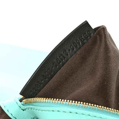 Sequin baguette bag interior view with zip top and black logo detail panel