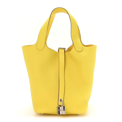 Lime leather tote with top handles and front vertical turn-lock clasp
