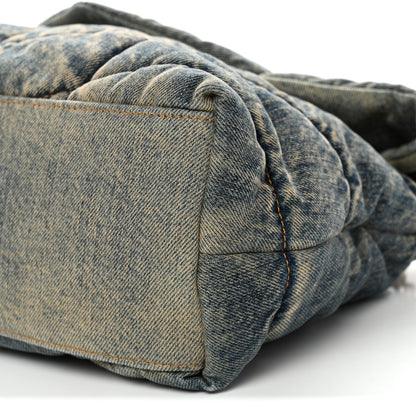 Denim puffer satchel corner with quilted panels and flap edge