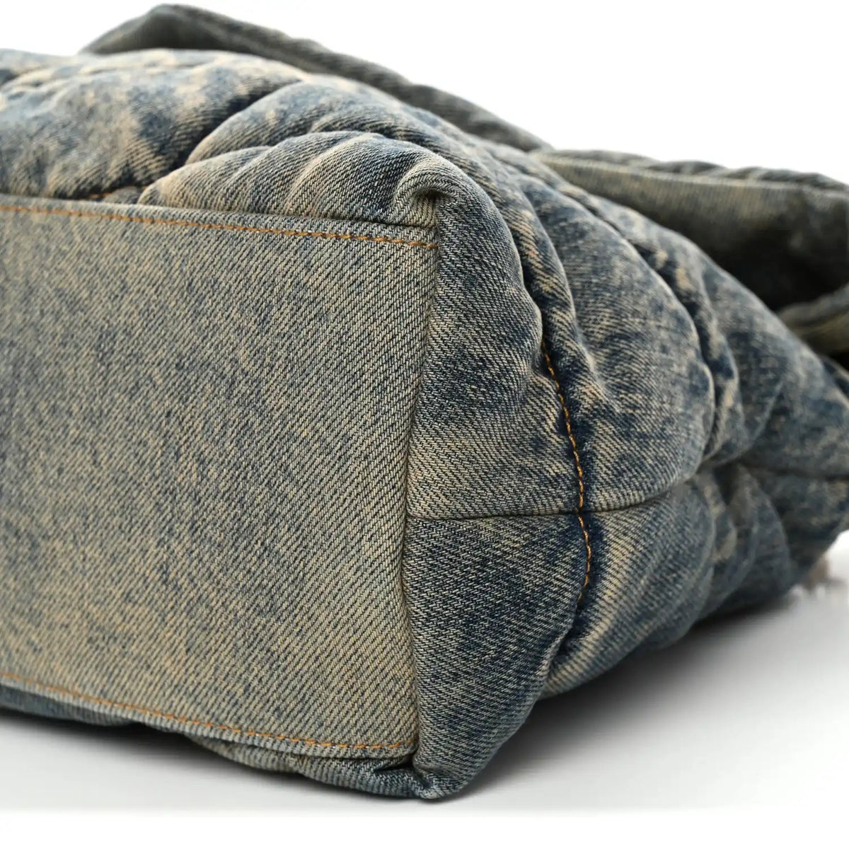 Denim puffer satchel corner with quilted panels and flap edge