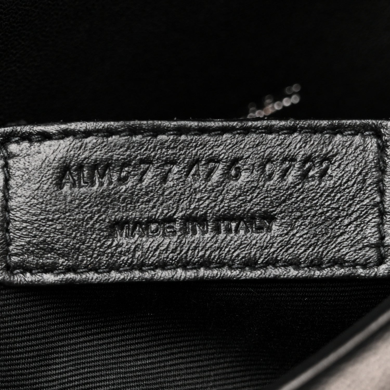 Made in Italy leather label on black satchel interior lining