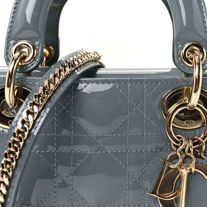 Light blue patent mini Lady Dior bag front detail with chain link strap and gold rings