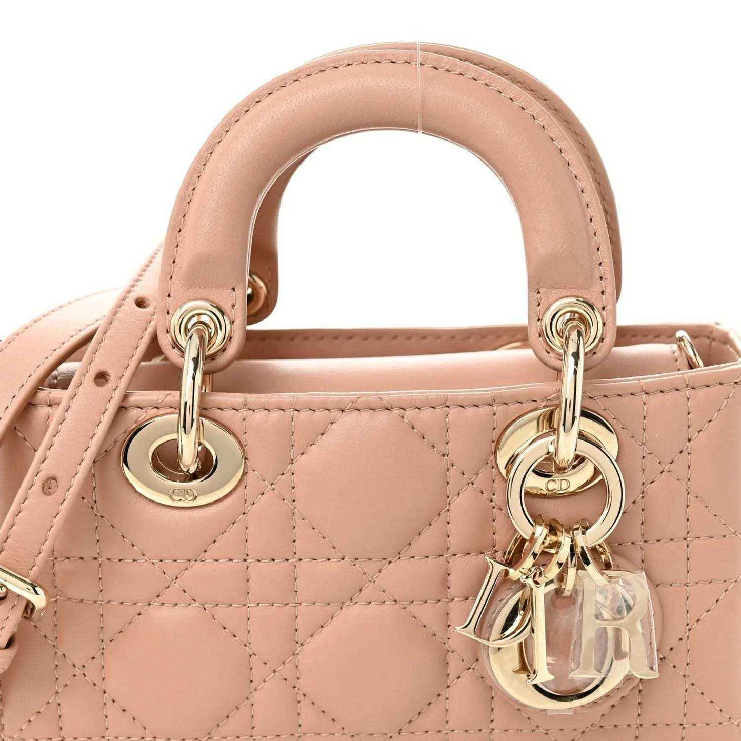 Pink beige micro handbag front with quilted cannage pattern, top rings, and gold hardware