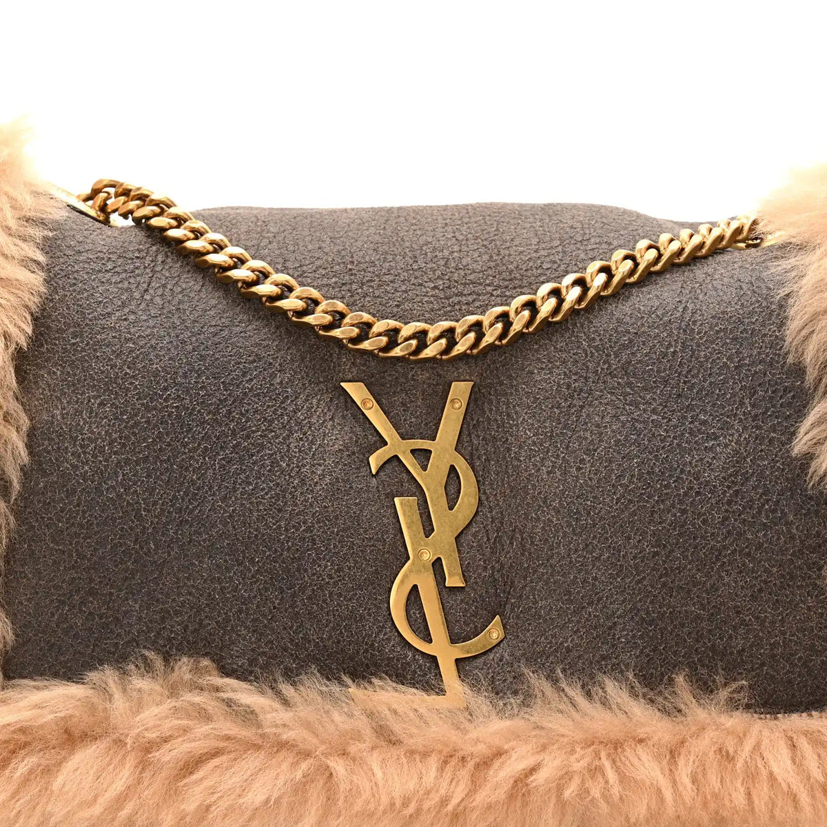 Saint Laurent reversible satchel with dark leather front, YSL monogram charm, gold chain