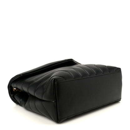 Black quilted leather chain satchel back view, rounded corners and stitched panels.