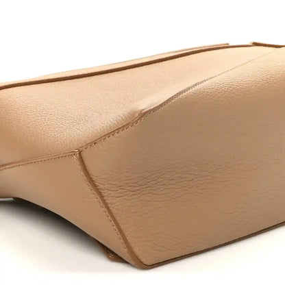 Toffee small Puzzle Edge bag close-up of side panel seam and leather grain