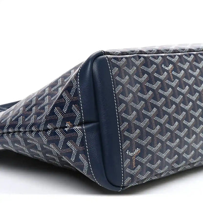 Navy tote bag side close-up with curved leather trim and stitched seams