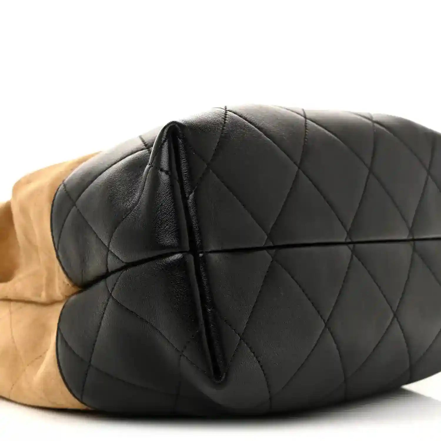 Chanel quilted black shopping bag side view with top fold seam and beige underlay