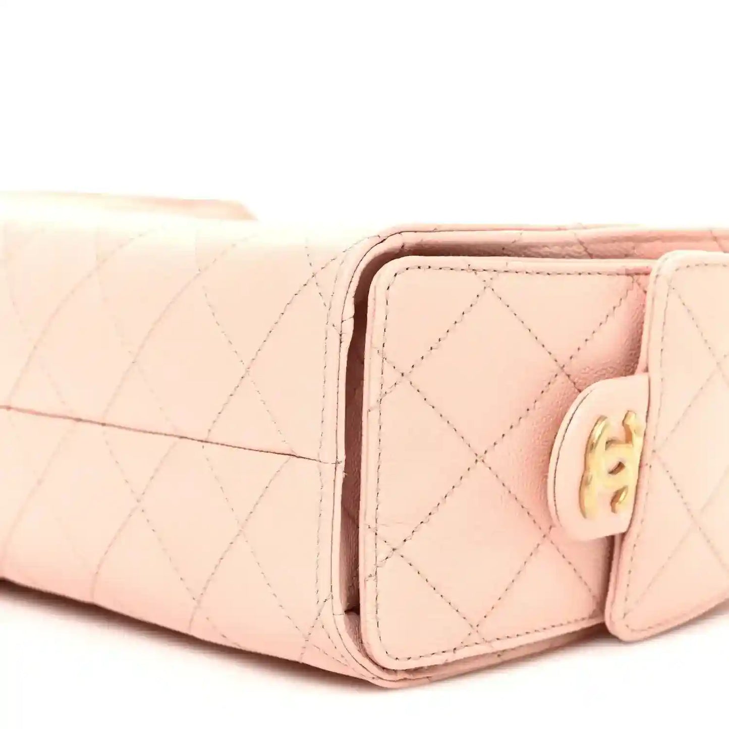 Light pink quilted mini handbag side view with front flap and gold-tone hardware