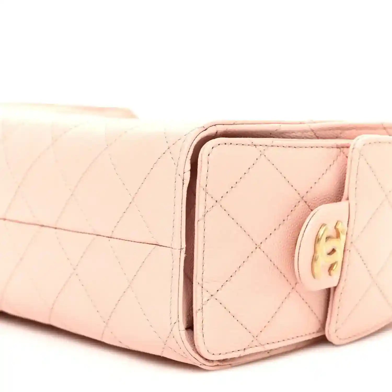 Light pink quilted mini handbag side view with front flap and gold-tone hardware