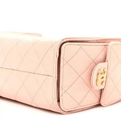 Light pink quilted mini handbag side view with front flap and gold-tone hardware
