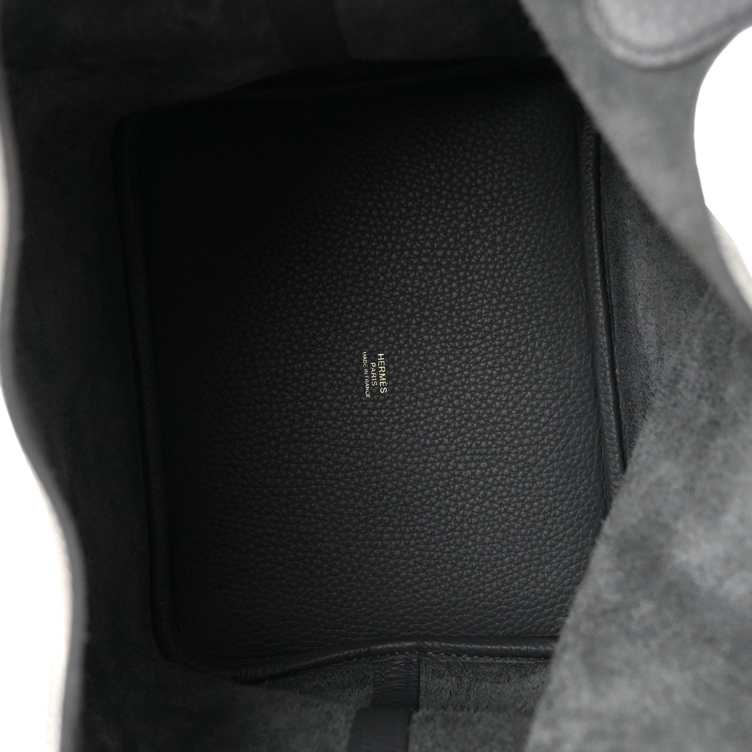 Interior of dark gray leather handbag showing subtle embossed brand text