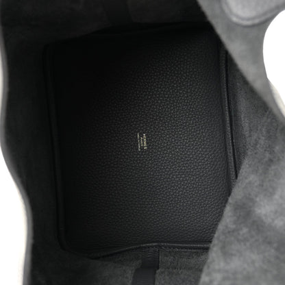 Interior of dark gray leather handbag showing subtle embossed brand text
