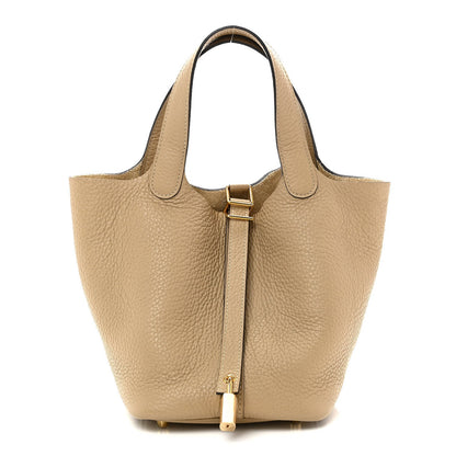 Beige grained calfskin bucket handbag with top handles and gold lock clasp.