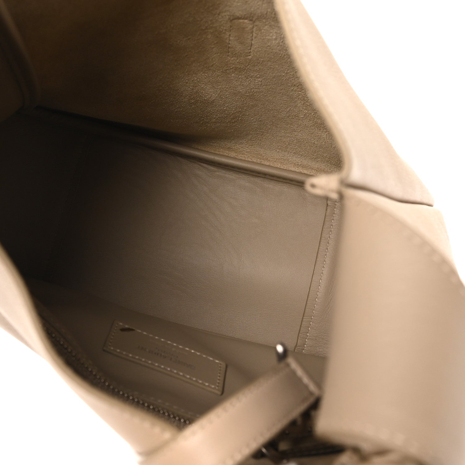 Beige leather hobo bag interior with stitched pocket and snap tab