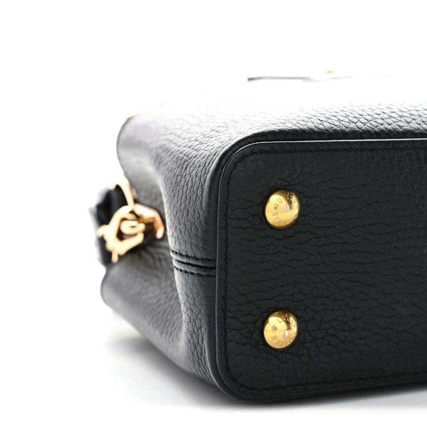 Black mini handbag side close-up with gold stud buttons and shoulder strap