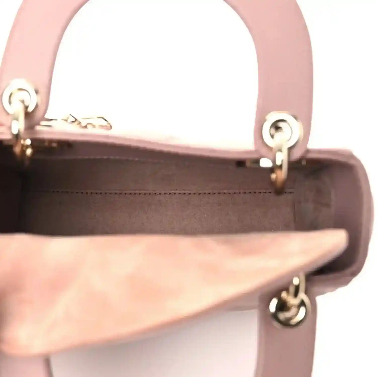 Mini Lady Dior handbag interior opening view with pink leather lining and gold-tone ring hardware.