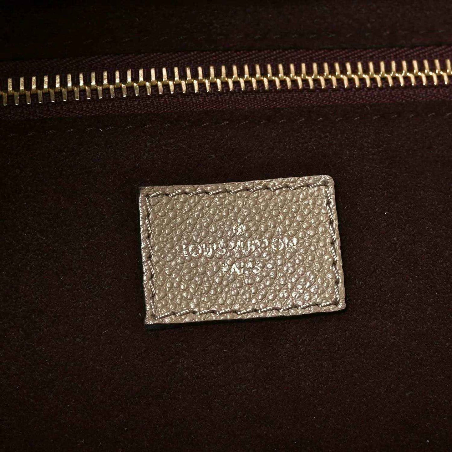 Louis Vuitton Neverfull MM tote bag interior label with gold-tone zipper