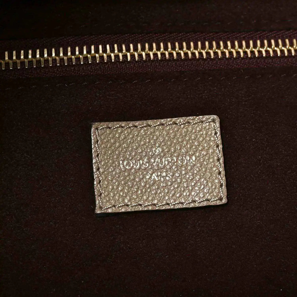 Louis Vuitton Neverfull MM tote bag interior label with gold-tone zipper