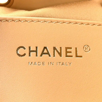 Chanel suede logo patch with “CHANEL” and “MADE IN ITALY” on beige fabric
