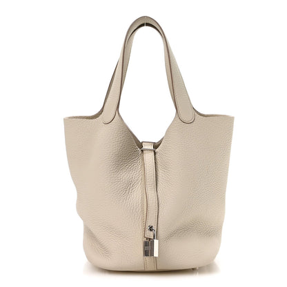 Ivory leather tote bag with top handles and metal lock detail