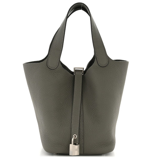 Tote-style leather bucket bag with two rolled handles and center zip pocket, dark green