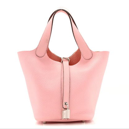 Rose pink leather tote handbag with top handles and hanging front lock