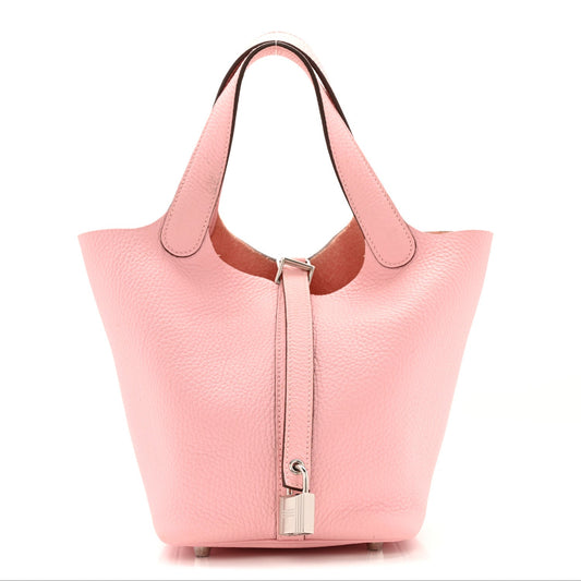 Rose pink leather tote handbag with top handles and hanging front lock