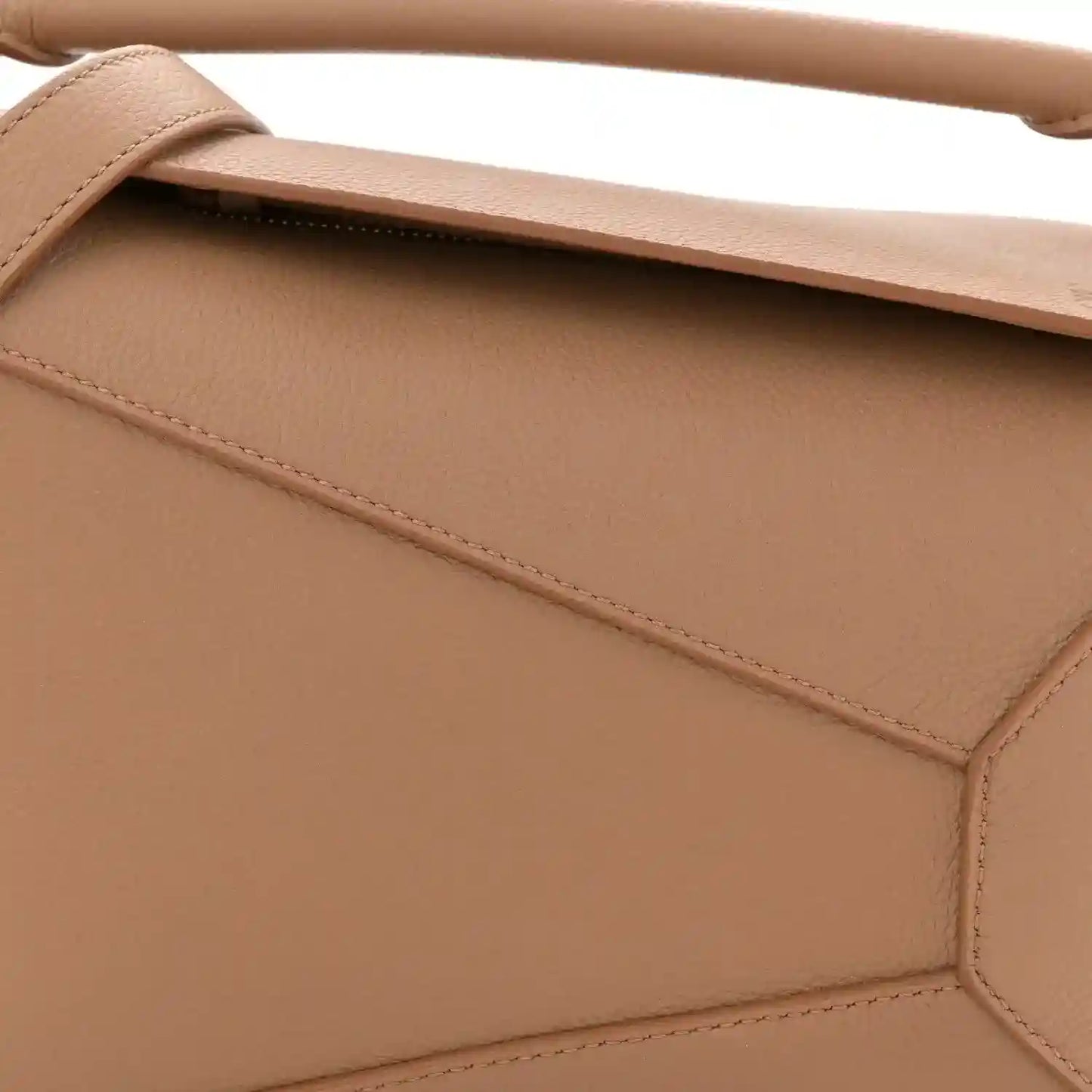 Toffee leather bag front panel with diagonal seam and top strap