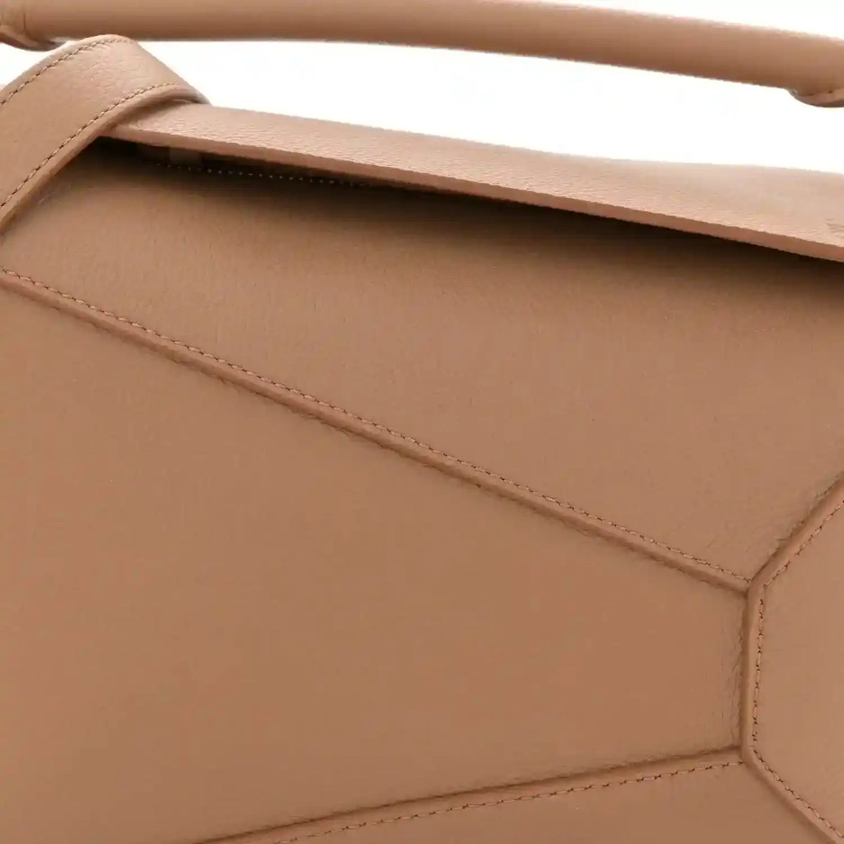 Toffee leather bag front panel with diagonal seam and top strap