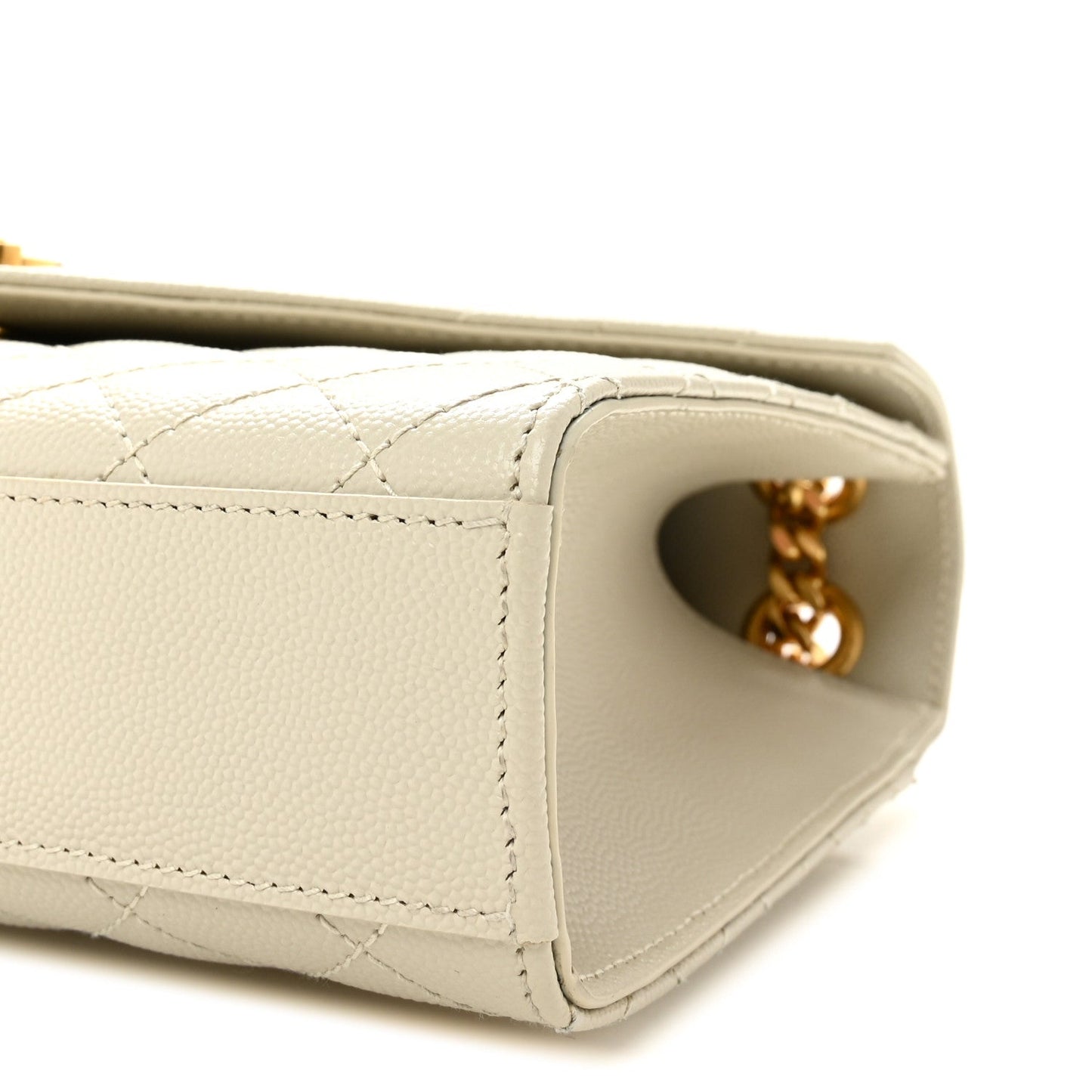 Cream quilted satchel side panel with stitching and gold chain connector