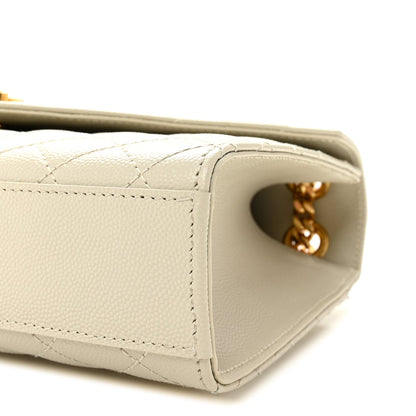 Cream quilted satchel side panel with stitching and gold chain connector